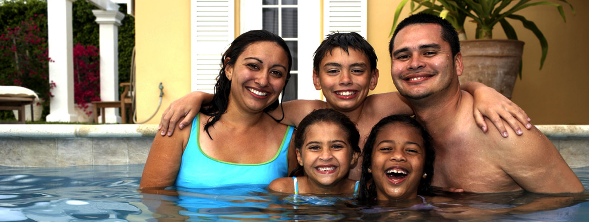 happy family in swimming pool